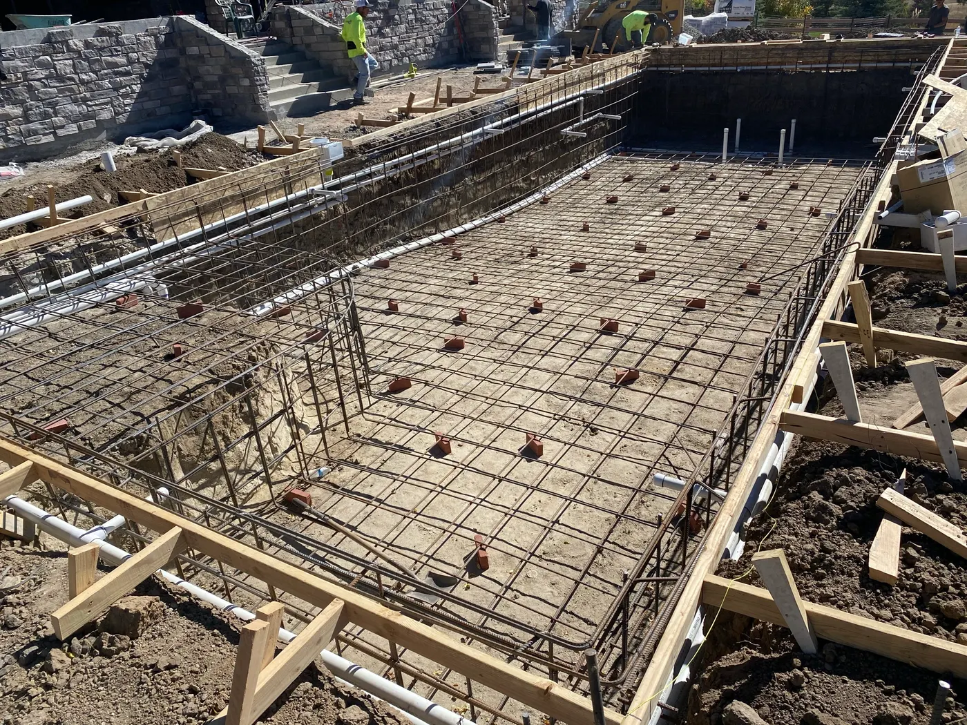 Pool under construction — steel reinforcement placed and tied before the shell is poured