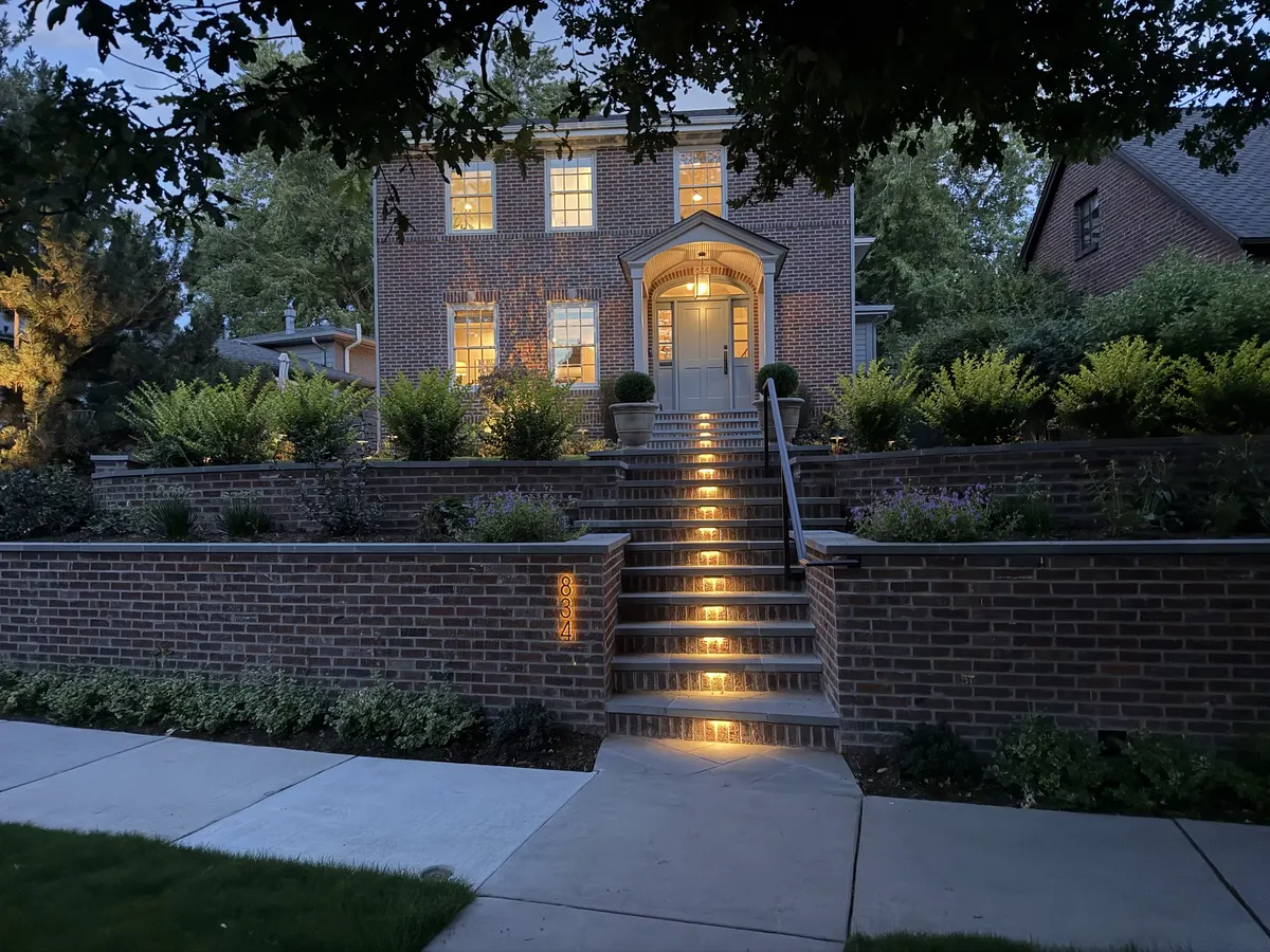 Illuminated garden stairs and planting at dusk